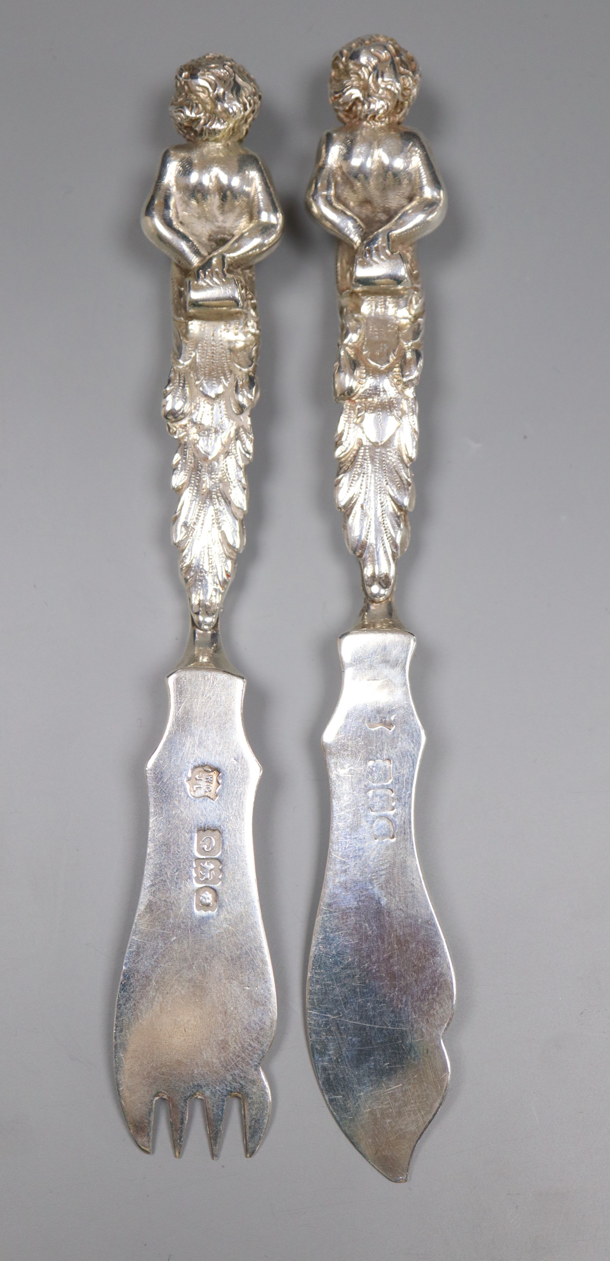 A pair of late Victorian silver fish eaters with figural handles by Goldsmiths & Silversmiths Co Ltd, London, 1898,